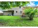 Lush green backyard featuring mature trees and a pergola-covered deck, providing a relaxing outdoor space at 11620 E 75Th St, Indianapolis, IN 46236