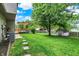 Spacious backyard featuring a stone walkway, mature trees, shed, and a deck with a pergola at 11620 E 75Th St, Indianapolis, IN 46236