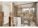Shower in tiled bathroom featuring glass door, bench and recessed lighting at 11620 E 75Th St, Indianapolis, IN 46236