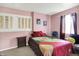 Bedroom featuring a bed, windows with blinds, and comfortable seating at 11620 E 75Th St, Indianapolis, IN 46236