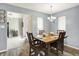 Formal dining room with a wooden table set for dinner and natural light at 11620 E 75Th St, Indianapolis, IN 46236