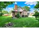 Charming two-story brick home with a manicured lawn and flower bed at 11620 E 75Th St, Indianapolis, IN 46236
