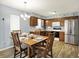 Well-equipped kitchen and dining area featuring stainless steel appliances and wood cabinetry at 11620 E 75Th St, Indianapolis, IN 46236