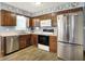 Bright kitchen featuring stainless steel appliances, light countertops, and ample cabinet space at 11620 E 75Th St, Indianapolis, IN 46236