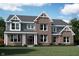 Stunning two-story home with brick and siding, a welcoming front porch, and beautiful architectural details at 11841 Sage Creek Bnd, Fishers, IN 46037