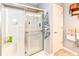 Bright bathroom featuring a glass-enclosed shower, shelving, decorative towels, and a white door at 12092 Sugar Creek Rd, Noblesville, IN 46060