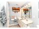 Charming bathroom with a double sink vanity, decorative towels, shelving, and ample lighting at 12092 Sugar Creek Rd, Noblesville, IN 46060