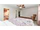 Bright bedroom featuring a ceiling fan, rocking chair, and doors leading to the bathroom and hallway at 12092 Sugar Creek Rd, Noblesville, IN 46060