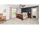 Cozy bedroom with accent wall, neutral carpet, and ample sunlight at 12092 Sugar Creek Rd, Noblesville, IN 46060