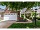 Charming brick home with a well-manicured lawn, inviting front porch, and attached two-car garage at 12092 Sugar Creek Rd, Noblesville, IN 46060