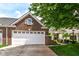 Beautiful brick home features a white garage door, green shutter, and cozy front porch at 12092 Sugar Creek Rd, Noblesville, IN 46060