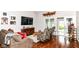 Cozy living room features hardwood floors, comfortable seating, and access to an outdoor patio area at 12092 Sugar Creek Rd, Noblesville, IN 46060