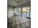 Bright sunroom featuring a tile floor, white shutters, and access to the backyard patio at 12092 Sugar Creek Rd, Noblesville, IN 46060