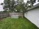 The backyard features a metal stock tank garden and green grass with a small tree at 1309 N Colorado Ave, Indianapolis, IN 46201