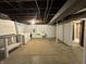 Open basement featuring a laundry area, utility sink, and concrete flooring at 1309 N Colorado Ave, Indianapolis, IN 46201