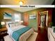 Virtually staged bedroom with colorful bedding, coordinated decor, and wood floors at 1309 N Colorado Ave, Indianapolis, IN 46201