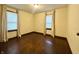 Empty bedroom featuring hardwood floors, neutral walls, and two bright windows at 1309 N Colorado Ave, Indianapolis, IN 46201