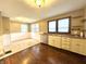 Bright kitchen featuring tan cabinets, tile floors, and stainless steel appliances at 1309 N Colorado Ave, Indianapolis, IN 46201