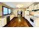 Functional kitchen featuring white appliances, light countertops, and hardwood floors at 1309 N Colorado Ave, Indianapolis, IN 46201