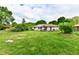 Wide-open backyard with a shed and mature trees offering privacy and shade at 135 Hickory Ct, Greenwood, IN 46142