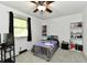Bright bedroom features neutral walls, carpeted floors, ceiling fan, and built-in shelving at 135 Hickory Ct, Greenwood, IN 46142