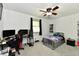 Spacious bedroom features carpet, ceiling fan, bed, and desk for relaxation and productivity at 135 Hickory Ct, Greenwood, IN 46142