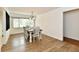 Bright dining room features wood floors, large window, and a wooden table with white chairs at 135 Hickory Ct, Greenwood, IN 46142