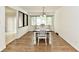 Bright dining room features wood floors, large window, and a wooden table with white chairs at 135 Hickory Ct, Greenwood, IN 46142