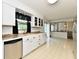 Open kitchen with a view to the dining area, featuring updated appliances and bright lighting at 135 Hickory Ct, Greenwood, IN 46142