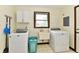Functional laundry room with modern washer, dryer, sink, and built-in storage for convenience at 135 Hickory Ct, Greenwood, IN 46142