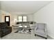 Inviting living room featuring plush seating, a glass table, and natural light from the window at 135 Hickory Ct, Greenwood, IN 46142