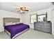 Cozy main bedroom featuring neutral carpet, ceiling fan, and a gray dresser with mirror at 135 Hickory Ct, Greenwood, IN 46142