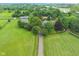 Sprawling estate home features mature trees, green lawns, barn, and a long driveway at 14655 Little Eagle Creek Ave, Zionsville, IN 46077