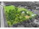 Aerial view of a home with mature trees, green space and a pond in a desirable neighborhood at 14655 Little Eagle Creek Ave, Zionsville, IN 46077