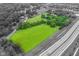 An aerial view shows lush green land with a neighboring highway at 14655 Little Eagle Creek Ave, Zionsville, IN 46077