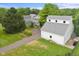 Aerial view of the property featuring a detached garage, lush greenery, and ample parking space at 14655 Little Eagle Creek Ave, Zionsville, IN 46077