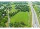 Aerial shot of lush green land next to a highway, showcasing the area's accessibility and natural beauty at 14655 Little Eagle Creek Ave, Zionsville, IN 46077
