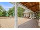 View of the backyard patio with ample space, outdoor kitchen area, and covered deck at 14655 Little Eagle Creek Ave, Zionsville, IN 46077