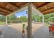 Backyard patio featuring a full outdoor kitchen, built-in grill, and covered area at 14655 Little Eagle Creek Ave, Zionsville, IN 46077