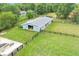 Aerial view of a fenced barn featuring a spacious green yard and a serene rural setting, offering a picturesque equestrian property at 14655 Little Eagle Creek Ave, Zionsville, IN 46077