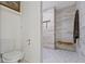 Bathroom showcasing a modern shower with tile surround and a toilet at 14655 Little Eagle Creek Ave, Zionsville, IN 46077