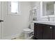 Bathroom featuring dark wood vanity, white toilet, light gray walls and neutral flooring at 14655 Little Eagle Creek Ave, Zionsville, IN 46077