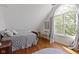 Charming bedroom with hardwood floors, a large window, and cozy decor at 14655 Little Eagle Creek Ave, Zionsville, IN 46077