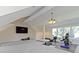 Bright bonus room with exercise equipment, TV, carpeted platform, and a beamed ceiling at 14655 Little Eagle Creek Ave, Zionsville, IN 46077