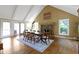Bright dining room with hardwood floors, brick fireplace, vaulted ceilings, and large windows at 14655 Little Eagle Creek Ave, Zionsville, IN 46077