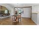 Dining area open to living room with hardwood floors and chandelier lighting at 14655 Little Eagle Creek Ave, Zionsville, IN 46077