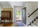 Inviting entryway with wooden chest, brick flooring and black accents creates an appealing and welcoming space at 14655 Little Eagle Creek Ave, Zionsville, IN 46077