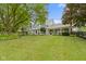 Charming two-story home with mature trees, manicured lawn, flowering plants and decorative shrubbery at 14655 Little Eagle Creek Ave, Zionsville, IN 46077