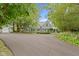 Charming gray two-story home with landscaped front yard and attached garage surrounded by mature trees at 14655 Little Eagle Creek Ave, Zionsville, IN 46077