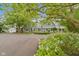 Charming gray two-story home with landscaped front yard and attached garage and surrounded by mature trees at 14655 Little Eagle Creek Ave, Zionsville, IN 46077